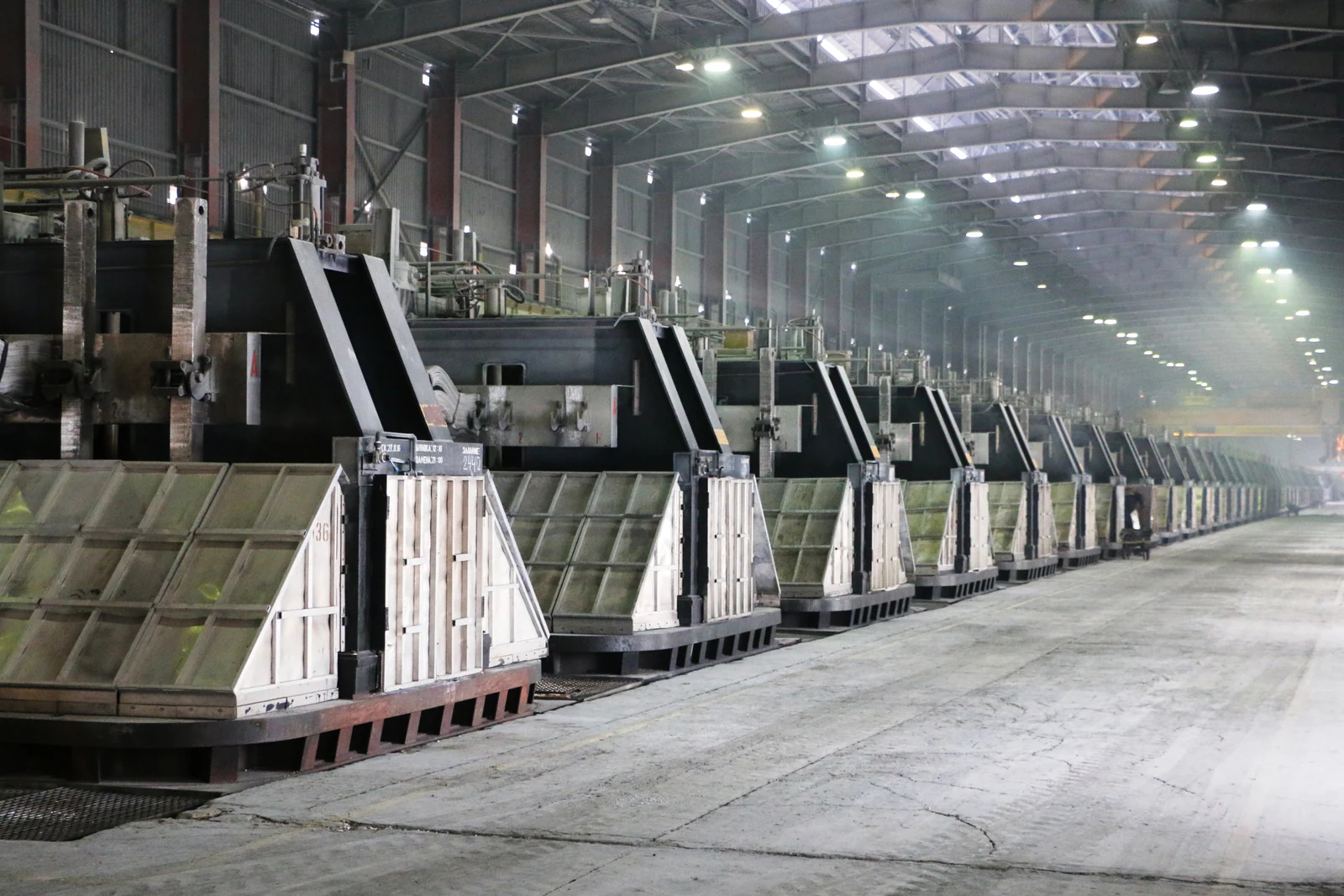 Interior of an aluminium smelter with rows of electrolytic cells
